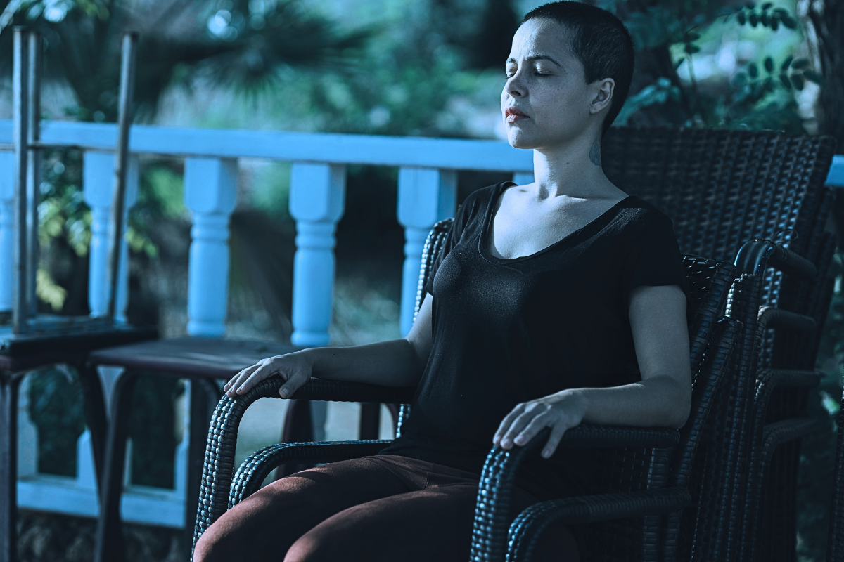 Woman in Black Top Meditating on Brown Armchair